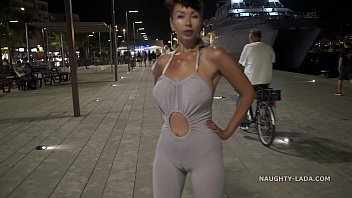 Naughty Lada wears backless coveralls and exposes her butt in public